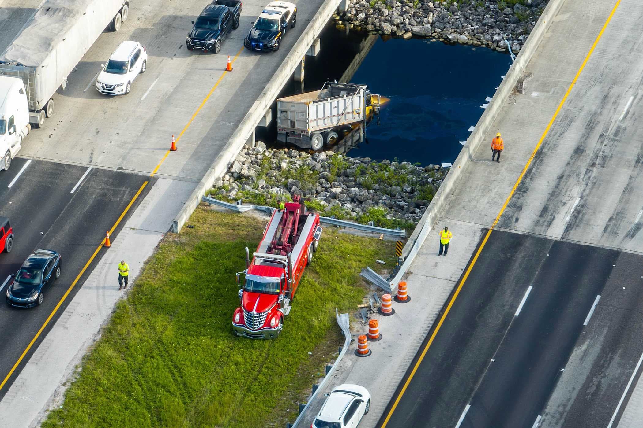 Dump truck partially submerged after crashing into canal along I-75