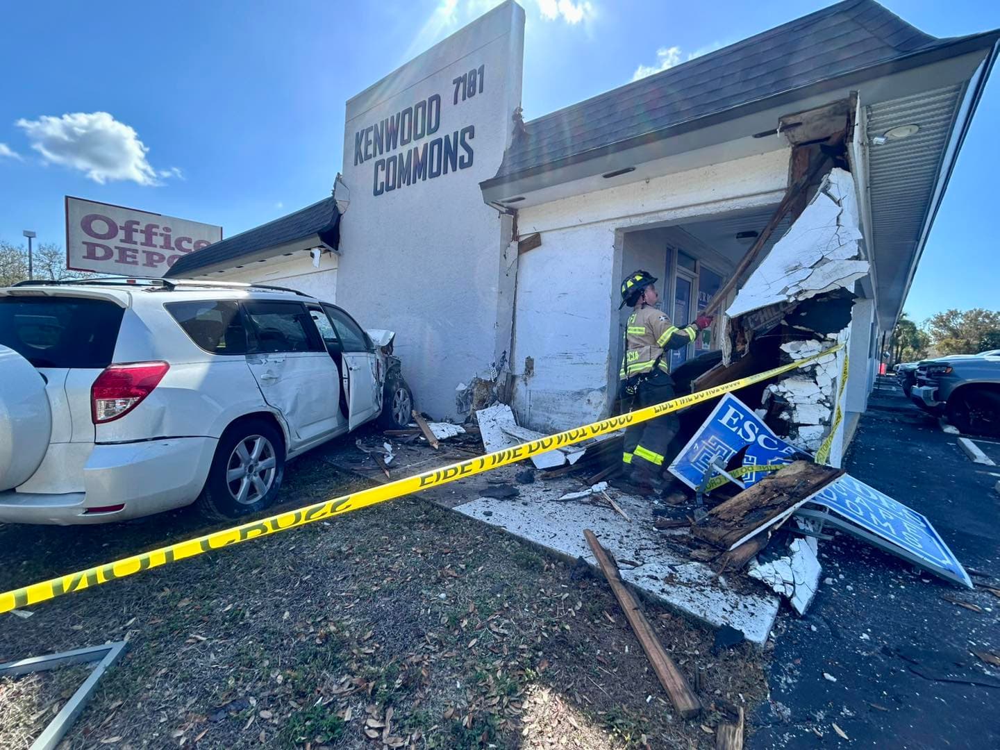 Car crash damages building exterior at College Parkway and Kenwood Lane